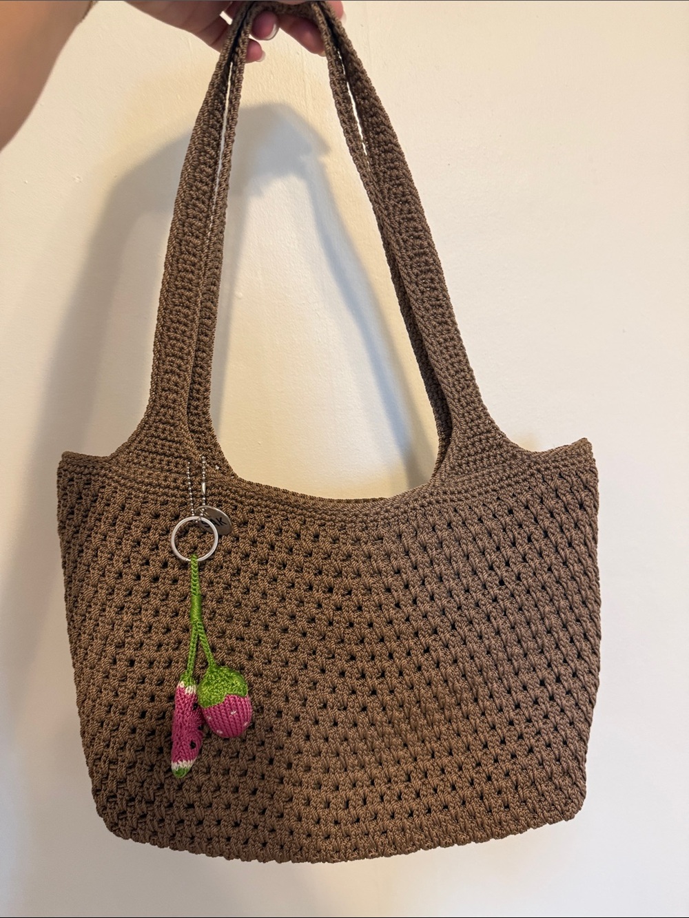 The Sak Brown Crochet Shoulder Bag with Pink Strawberry Charm